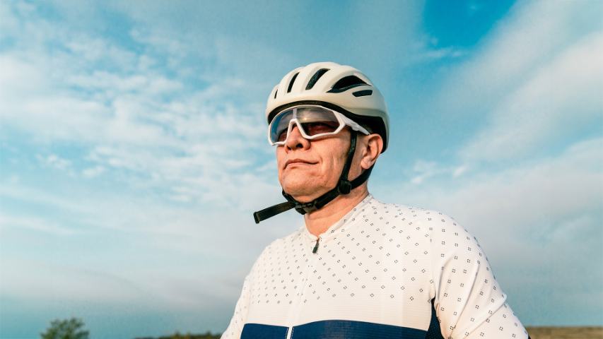 senior man cycling with helmet
