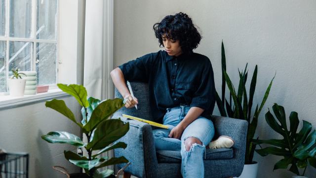 woman writting on digital tablet