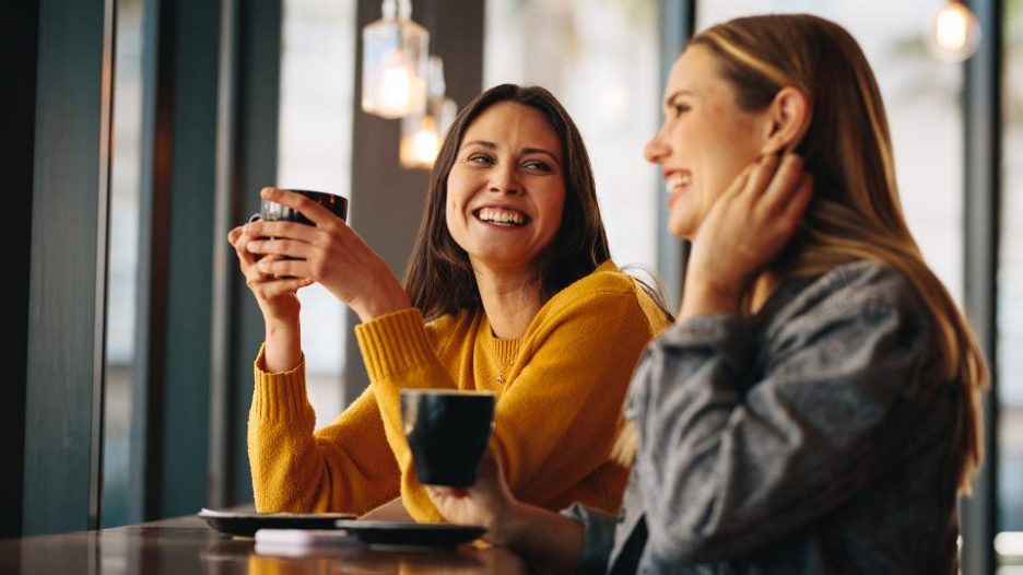 two women enjoying time together in a cafe