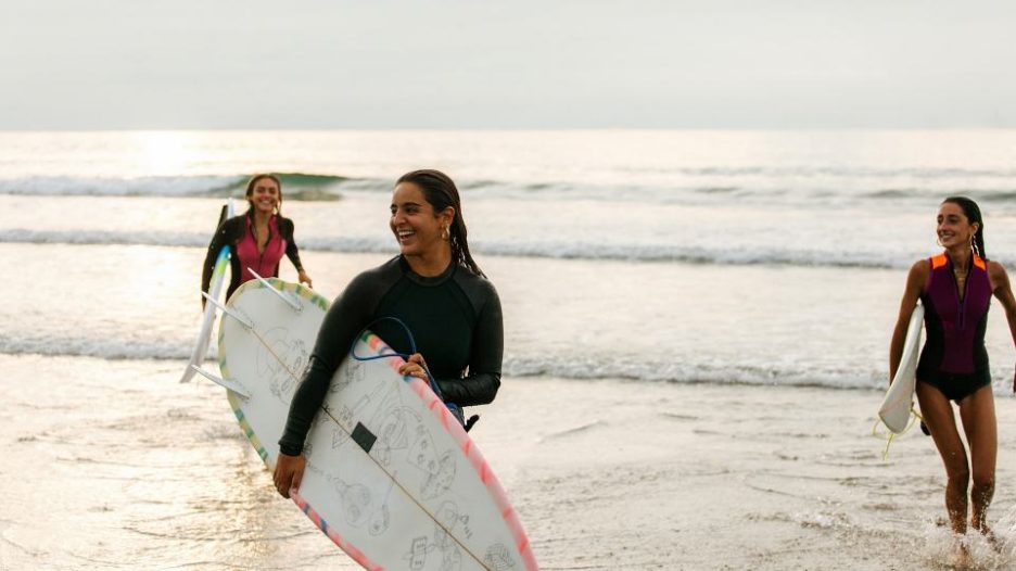friends exiting the ocean after a surf session